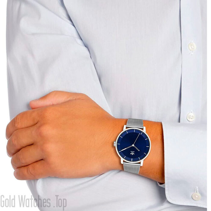 a man using an Adidas Z04-2928-00 silver watch blue dial adidas watch